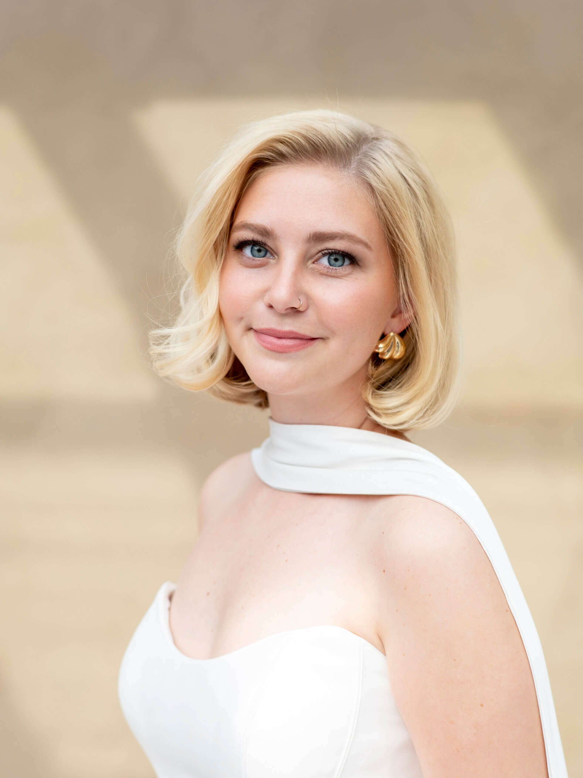A side view of a medium-length wavy hairstyle held in place by two pearl-adorned hairclips